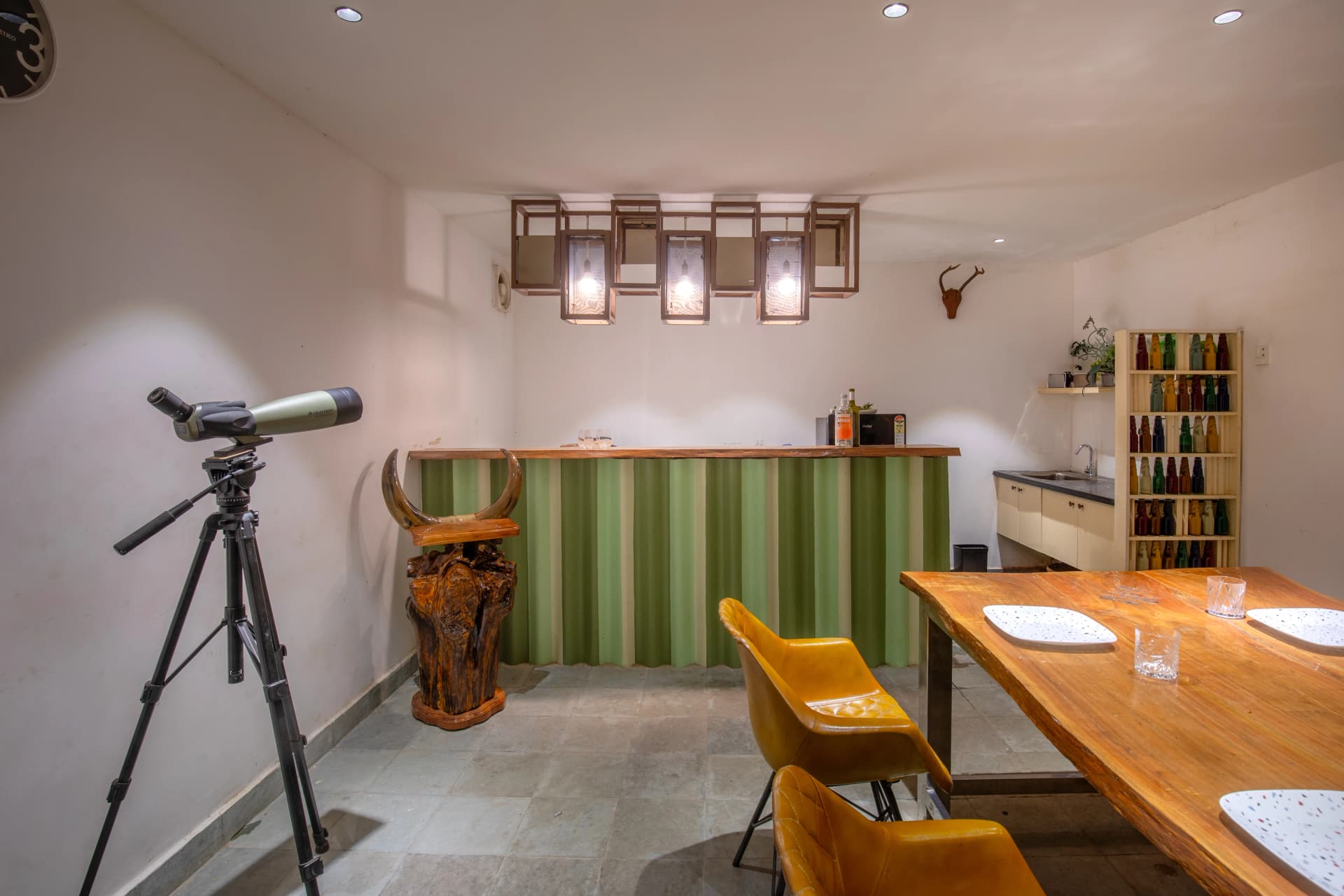 Completed interior with a sculptural bar, lighting and dining furniture